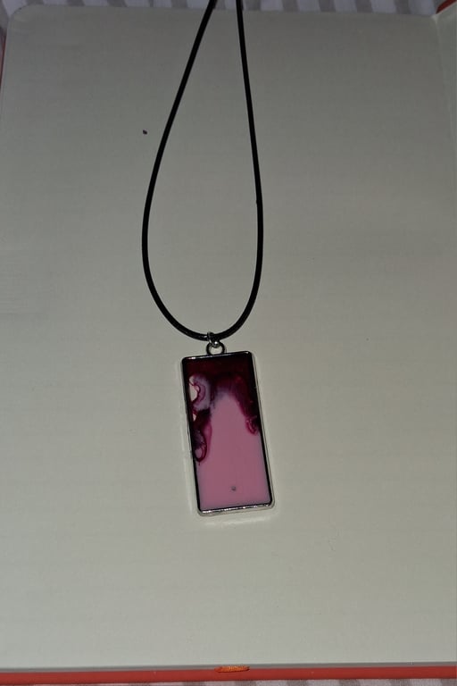 Handmade resin red and pink rectangular pendant on  black waxed cord
