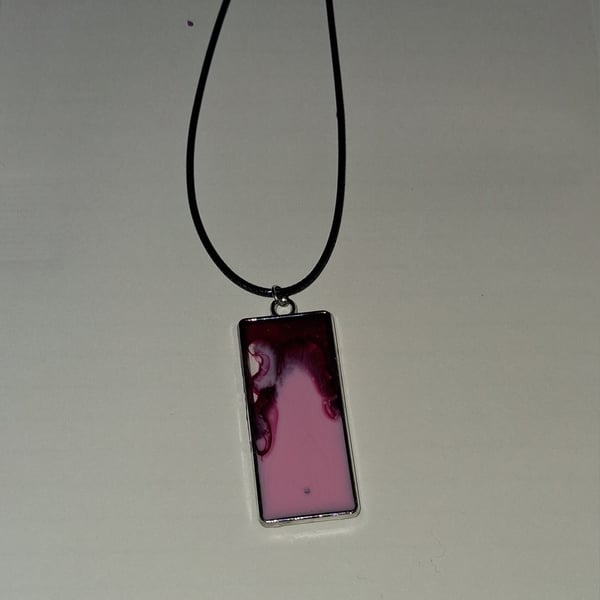 Handmade resin red and pink rectangular pendant on  black waxed cord