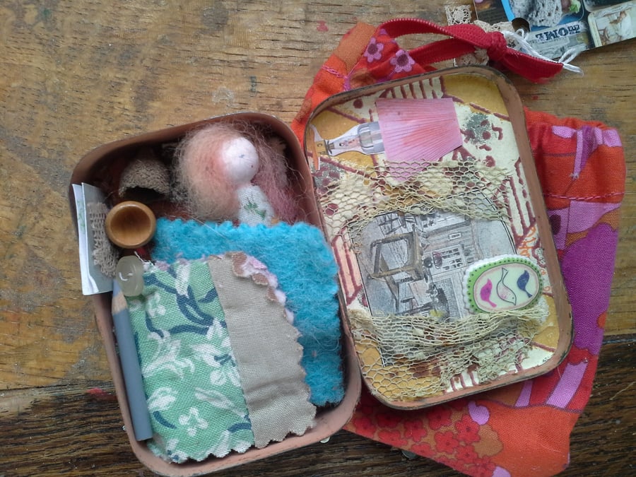 Dilly a travel doll in an art  tin.