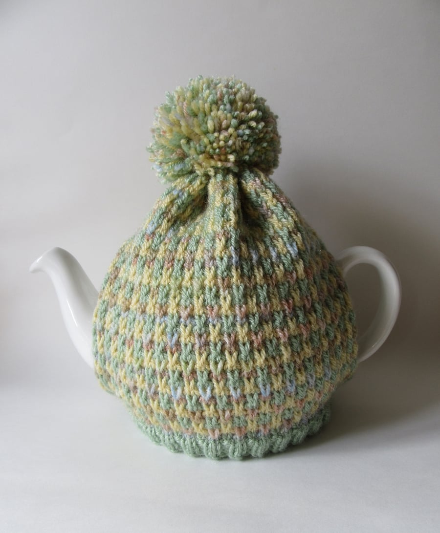 Knitted spring tweed tea pot cosie with oversized pompom