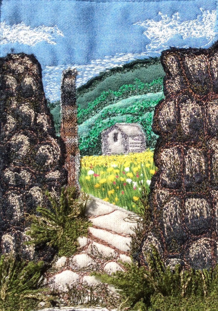 Up cycled fabric free motion embroidered landscape.