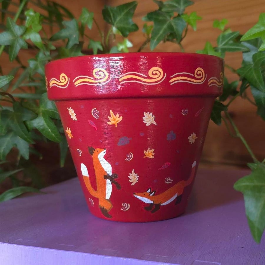 Hand painted playful foxes plant pot 