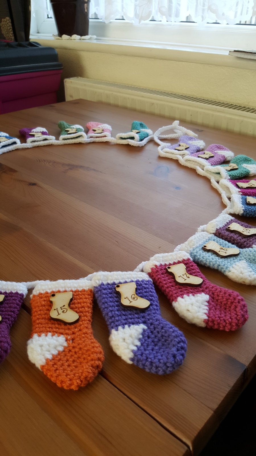 festive crocheted christmas stocking garland, multicoloured