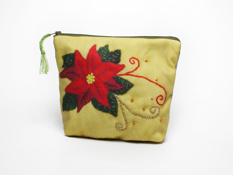 Make up bag with poinsettia design on the front with hand embroidered highlights