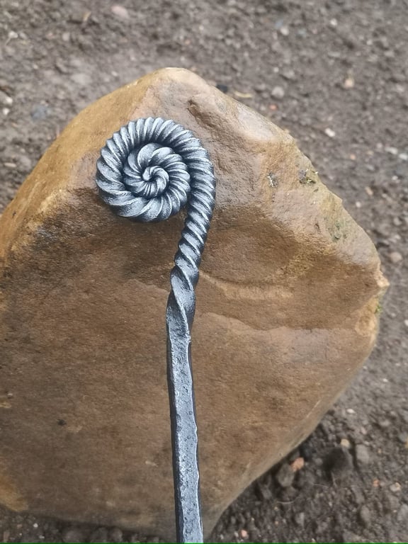 Ammonite style fire poker handcrafted in a blacksmiths forge