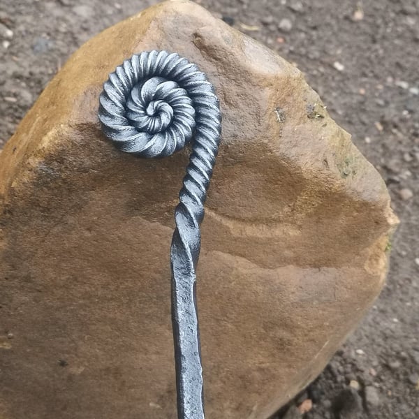 Ammonite style fire poker handcrafted in a blacksmiths forge