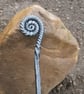 Ammonite style fire poker handcrafted in a blacksmiths forge
