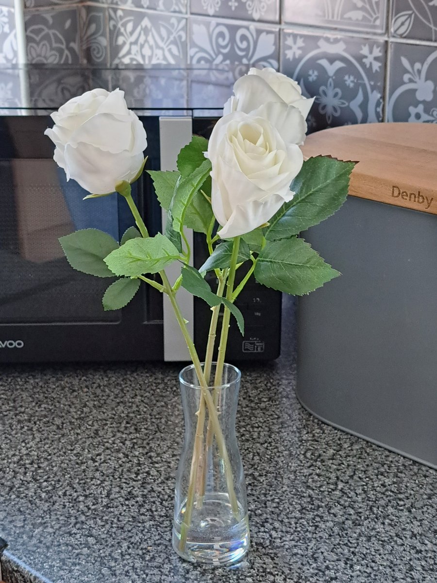 3 faux white roses in glass vase