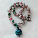 White, burgundy and green jade knotted cord necklace with ceramic pendant 