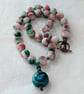 White, burgundy and green jade knotted cord necklace with ceramic pendant 