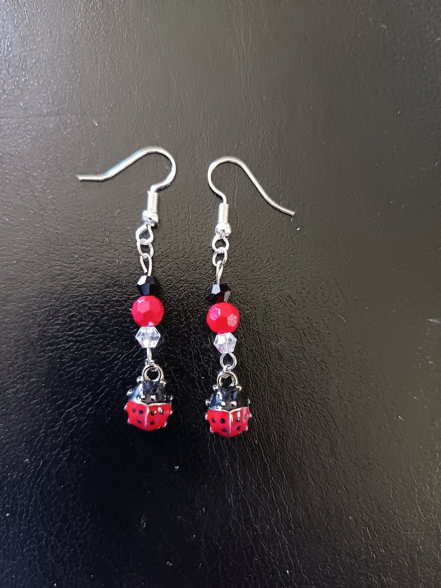 Beaded red, black and silver ladybird charm dangle earrings