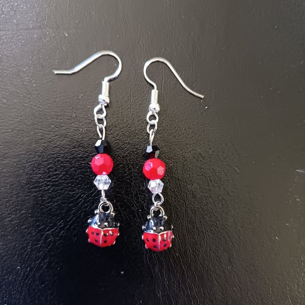 Beaded red, black and silver ladybird charm dangle earrings