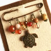Embellished kilt pin with turtle charm