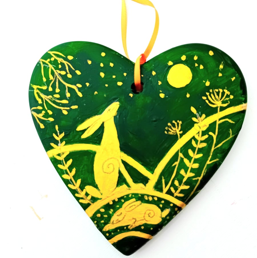 golden hare on a green ceramic heart