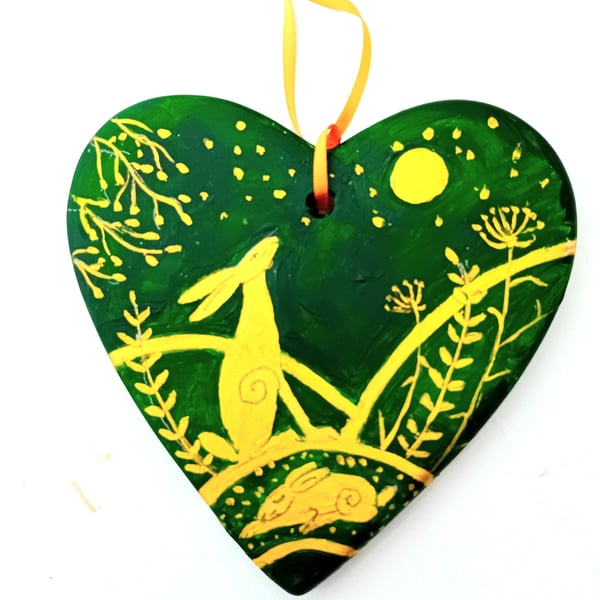 golden hare on a green ceramic heart