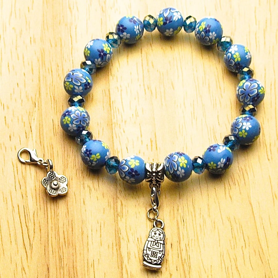 Blue Floral Polymer Bead Bracelet With Russian Doll and Flower Charms