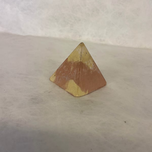 Pyramid made from traditional concrete mixtures indoor or garden ornament