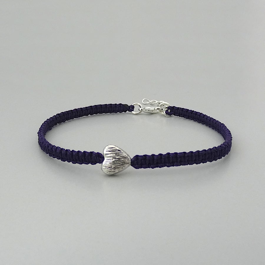 Purple 7" macramé bracelet with silver plated heart charm and 1” extender chain.