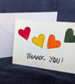 Hand-painted card featuring hearts and a handwritten “Thank You” message