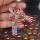 Initial keyring made from epoxy resin in the shape of the letter F