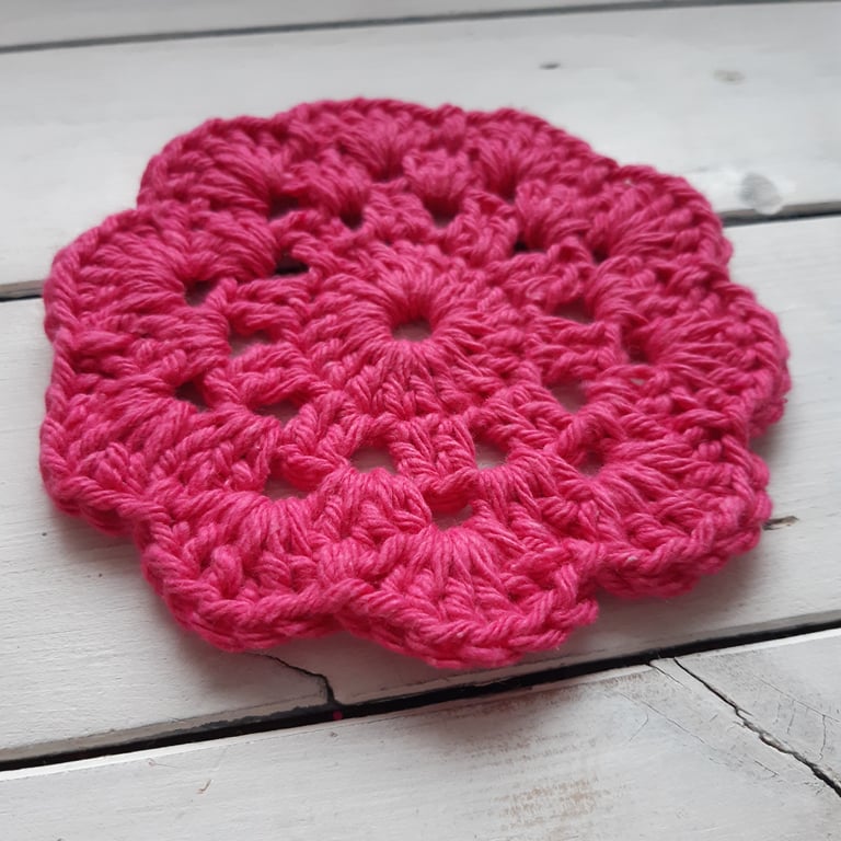 Pink crocheted tea coaster