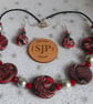 Disc shaped necklace in a red, black and silver swirl design - Image 4
