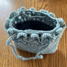 Pretty crochet handbag in pale blue recycled yarn, with a denim lining.