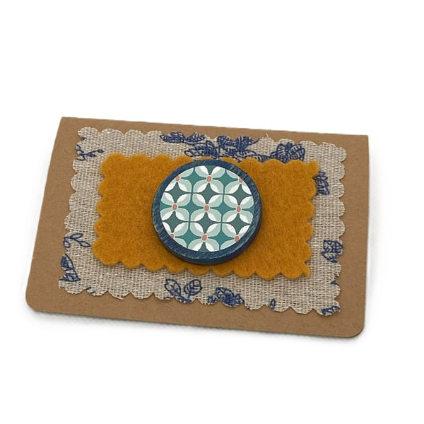 Wooden pin with a repeated floral pattern