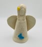 Angel sculpture with blue butterfly & yellow flower - Image 1
