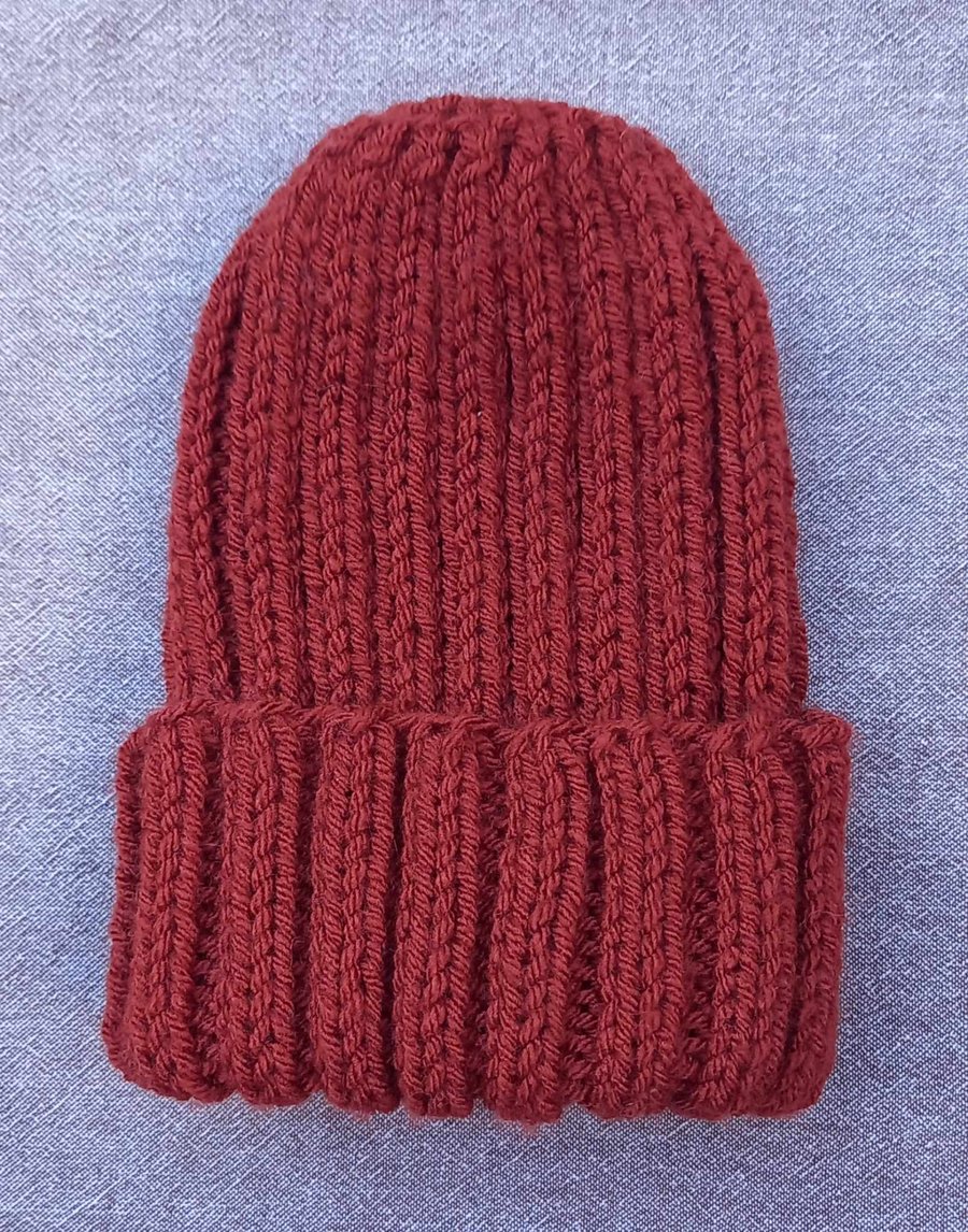 Adult ribbed hand knitted hat, rust colour