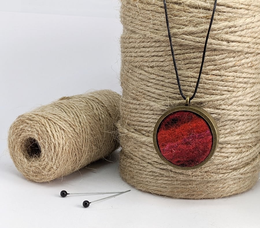 Felted pendant - shades of red in bronze bezel