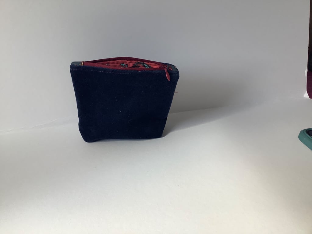 Navy blue velvet purse with a zip closure and a paisley cotton lining. 