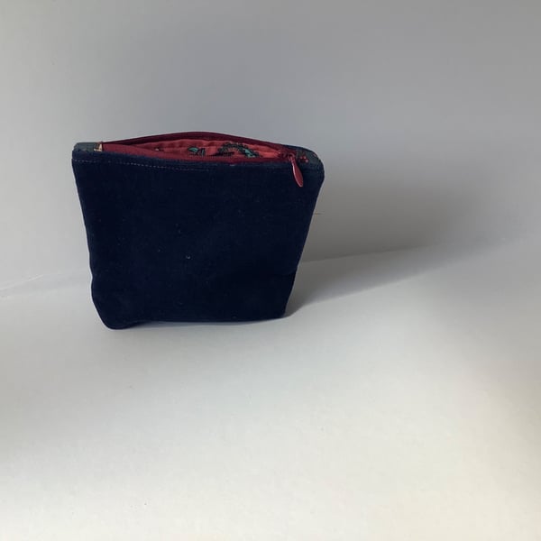 Navy blue velvet purse with a zip closure and a paisley cotton lining. 