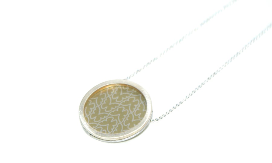 Silver and pale gold circle necklace - butterfly pattern