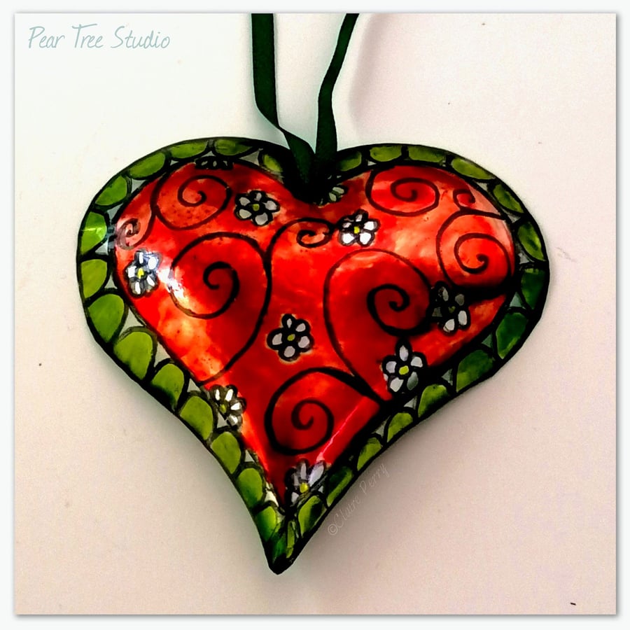 Handmade Small Metal Heart Decoration in red and green with a flower pattern.
