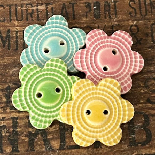 Set of four flower shaped ceramic handmade buttons 