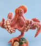 Needle felted Octopus in natural background of starfish and shells