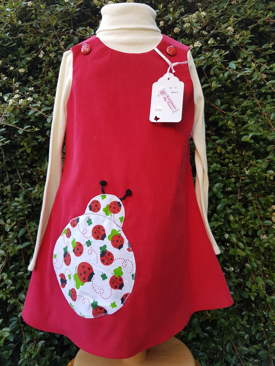 Age: 4-5y. Red baby needlecord pinafore dress. 