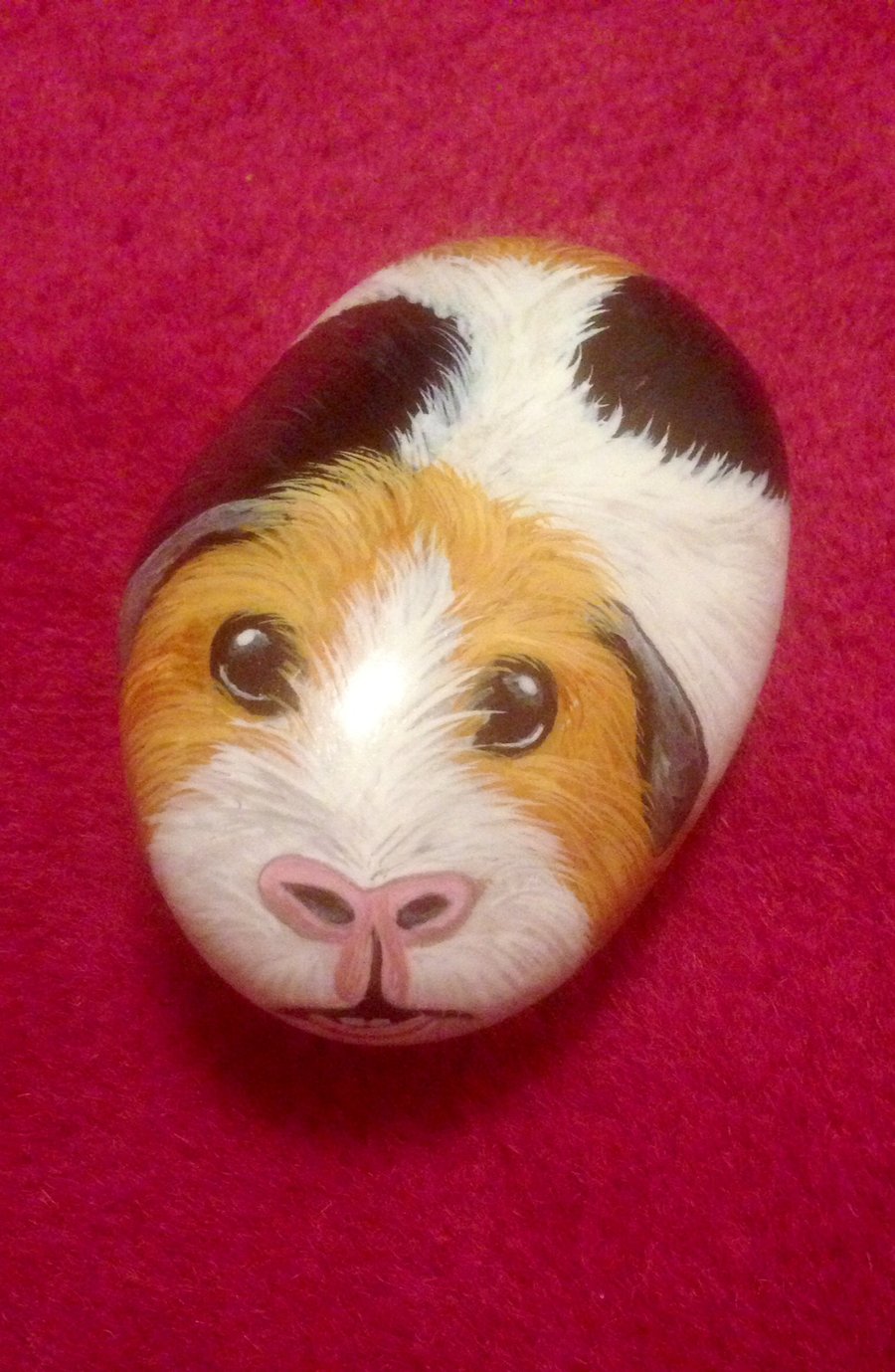 Guinea pig painted on stone 