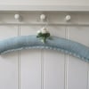 Hand knitted ladies coat hanger, blue with rose buds