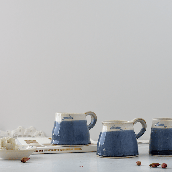 Handmade ceramic blue and white leaping hare mug - stoneware pottery