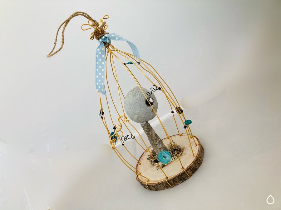 Wire bird cage with ceramic sculpture, fantasy art