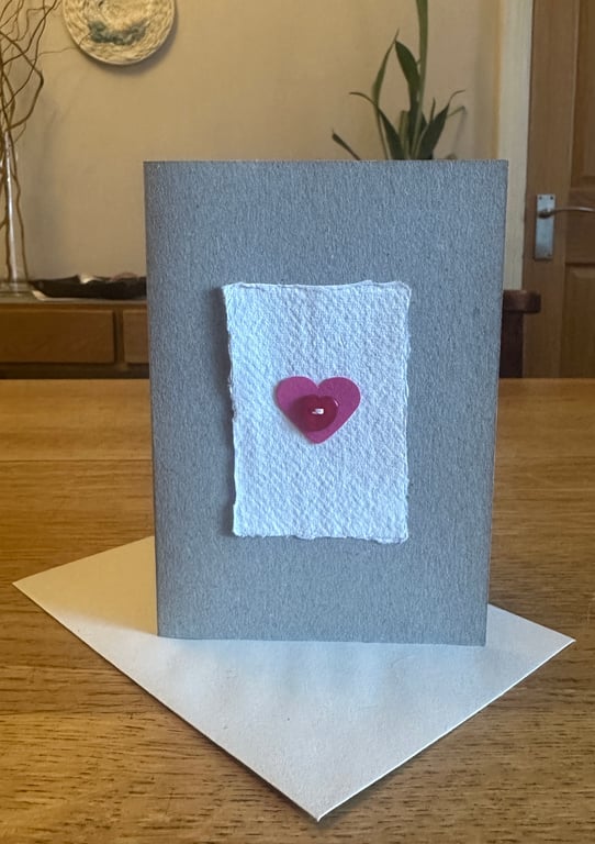 Greetings card with pink heart & red heart shaped button 