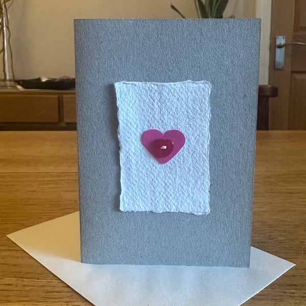 Greetings card with pink heart & red heart shaped button 