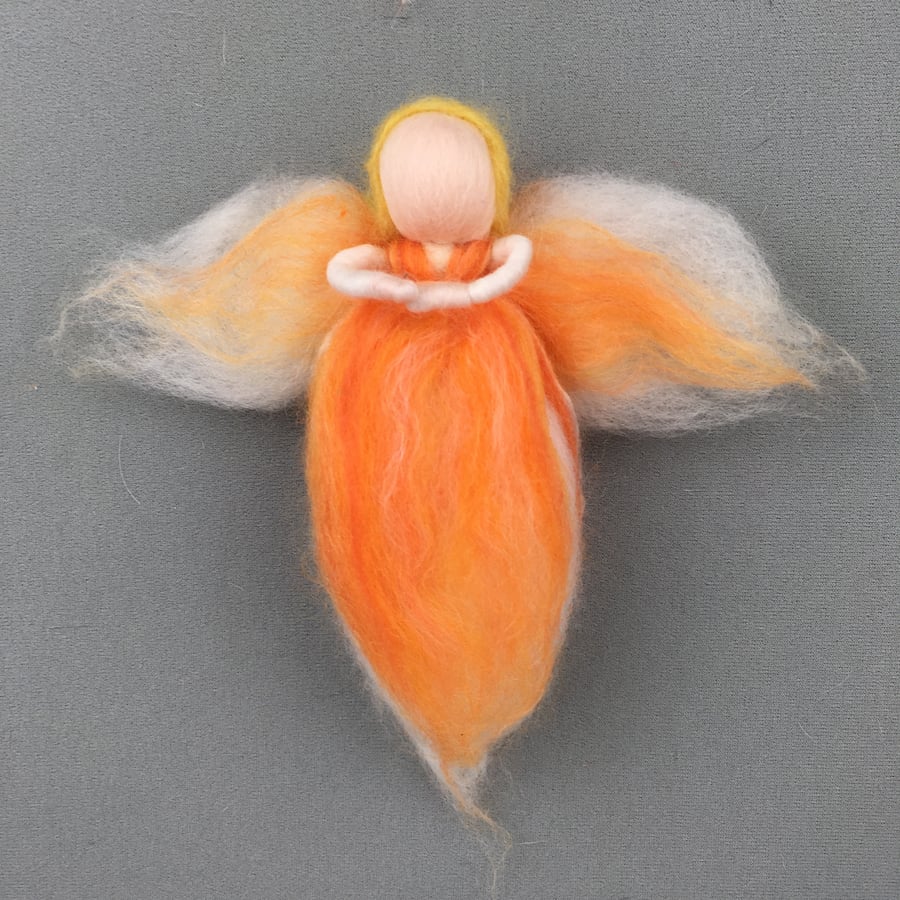 Hanging fairy or angel decoration in orange merino wool fibres