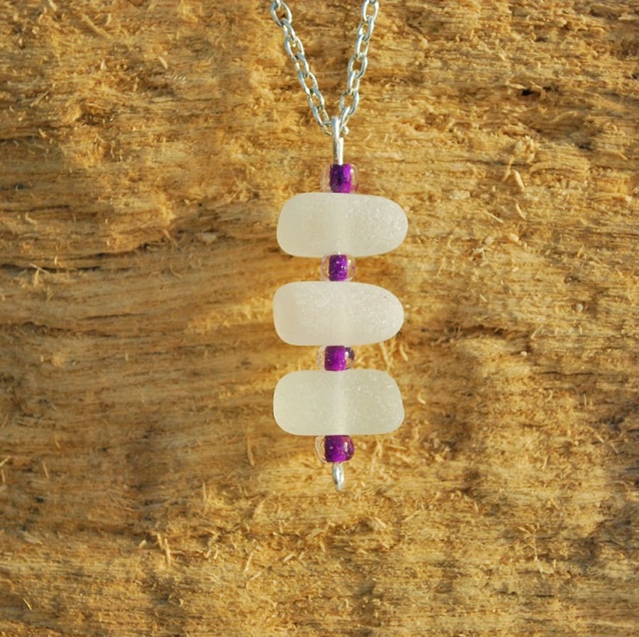 White sea glass pendant with purple beads