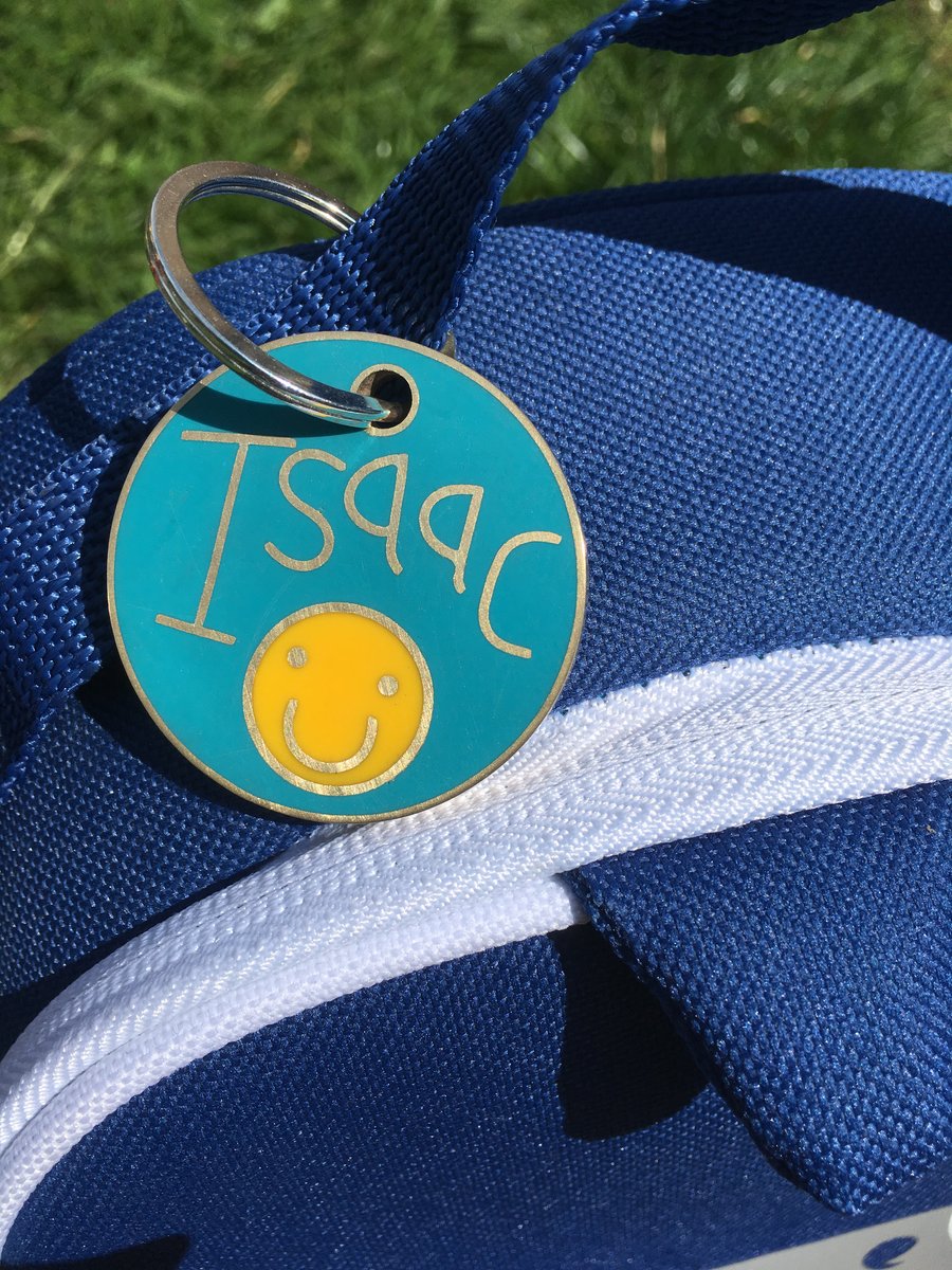 A personalised bag tag in resin and metal