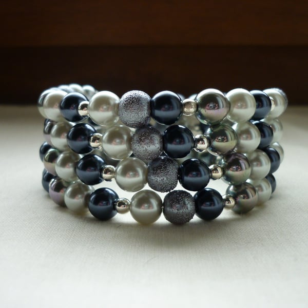 GREYS AND SILVER MEMORY WIRE BRACELET.  765