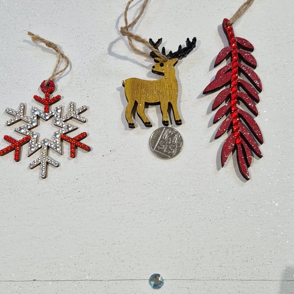 A set of three hand decorated wooden decorations.