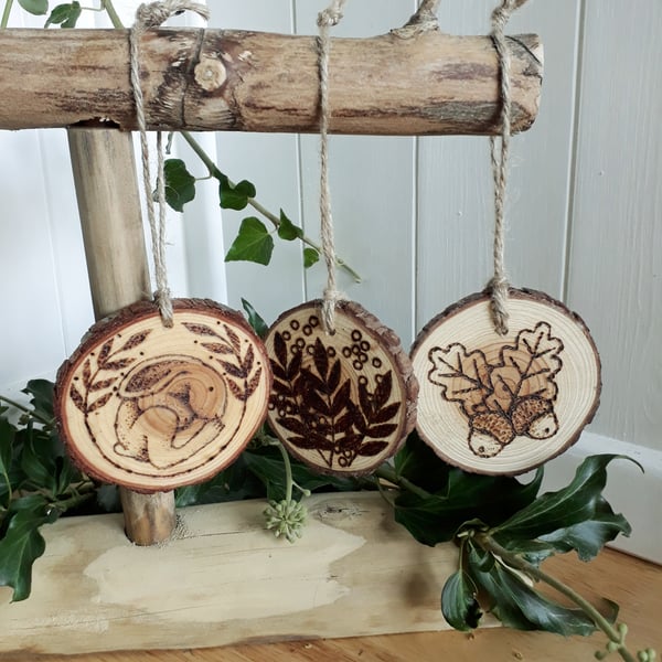 Three pyrography wood slice hanging decorations